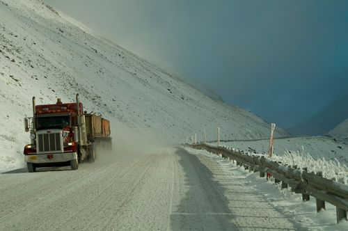 Semi truck driving on a snowy highway